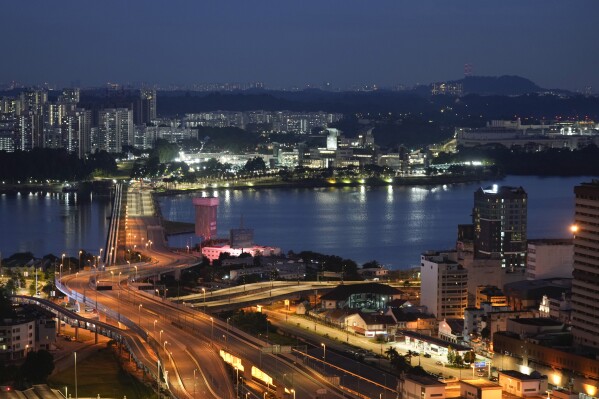 FILE- The Johor - Singapore Causeway lies empty in Johor Bahru, Malaysia, Nov. 28, 2021. (AP Photo/Vincent Thian, File)