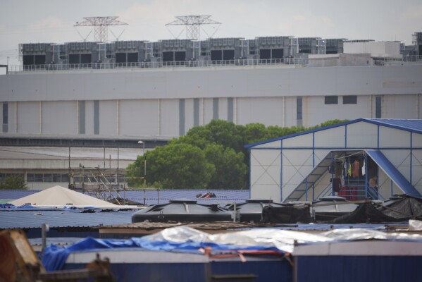 A lodging for construction workers is seen in front of a Data center in Sedenak Tech Park in Johor state of Malaysia, Friday, Sept. 27, 2024. (AP Photo/Vincent Thian)